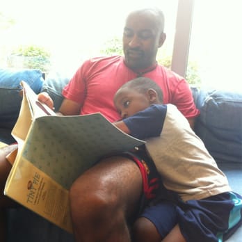 South Coastal Library - Daddy reading a book to his big boy on the super large comfy sectional in the children's area! - Libraries Near Me - Bethany Beach, Delaware South Coastal Library - Daddy reading a book to his big boy on the super large comfy sectional in the children's area! - Libraries Near Me - Bethany Beach, Delaware