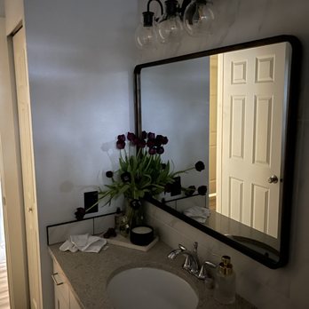 Shape Up Renovation - a sink and mirror in a bathroom - General Contractors Near Me - Federal Way, Washington Shape Up Renovation - a sink and mirror in a bathroom - General Contractors Near Me - Federal Way, Washington