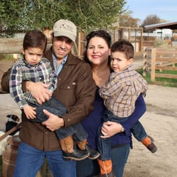 Nicolau Farms - Walter and Elizabeth Nicoloau at their farm with their two sons (Stanislaus Magazine cover)