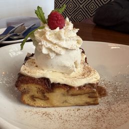 Bread pudding with fresh whipped cream, vanilla iced cream and a raspberry on top. Delicious!