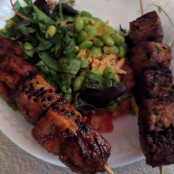 Cafe Yumm! - Argyle Square - Yumm bowl on greens with bbq tofu and teriyaki tempeh skewers - Wraps Near Me - Wilsonville, Oregon Cafe Yumm! - Argyle Square - Yumm bowl on greens with bbq tofu and teriyaki tempeh skewers - Wraps Near Me - Wilsonville, Oregon