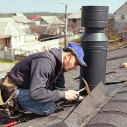 Phoenix Exteriors - Roofer installs shingle on asphalt roof