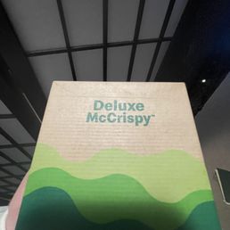 a person holding a box with a logo on it a person holding a box with a logo on it