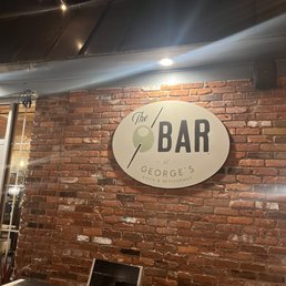 a brick wall with a sign on it a brick wall with a sign on it