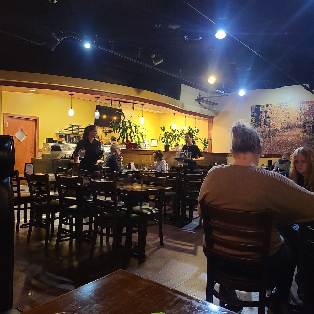 people sitting at tables in a restaurant people sitting at tables in a restaurant