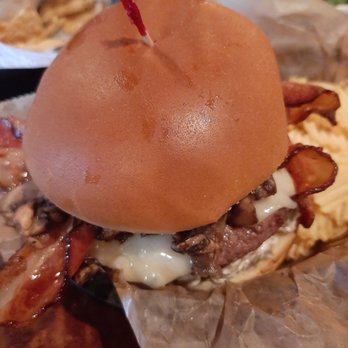 The Side Door Saloon - Olive mushroom bacon burger with Swiss cheese added. Side of chips - Sports Bars Near Me - Petoskey, Michigan The Side Door Saloon - Olive mushroom bacon burger with Swiss cheese added. Side of chips - Sports Bars Near Me - Petoskey, Michigan