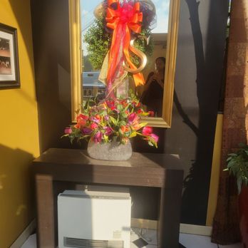 Sibio's Restaurant - a vase of flowers in front of a mirror - Italian Near Me - Dunmore, Pennsylvania Sibio's Restaurant - a vase of flowers in front of a mirror - Italian Near Me - Dunmore, Pennsylvania