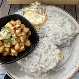 Biscuits and gravy with eggs and side of potatoes