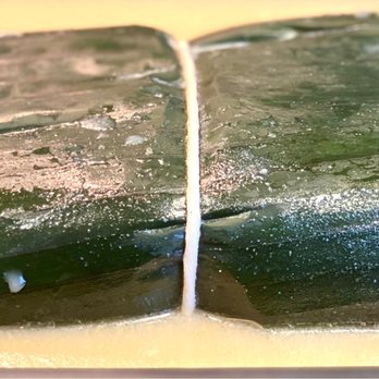Blue Max Meats - The pork roast is wrapped in banana leaves after being perfectly seasoned. - Butcher Near Me - Puyallup, Washington