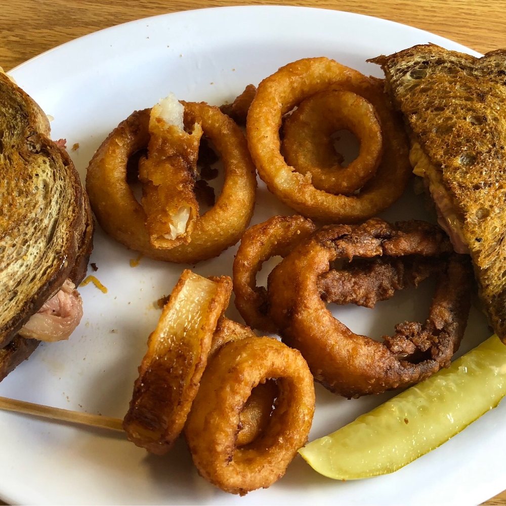 Rueben sandwich on marbled rye with onion rings as the side Rueben sandwich on marbled rye with onion rings as the side
