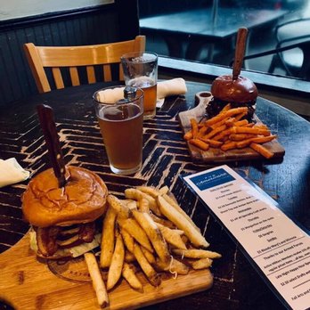 Pub Americana - The closest to the frame is the Greek burger with added bacon and the farthest is the Southern Barbecue burger. - Bars Near Me - Cocoa, Florida Pub Americana - The closest to the frame is the Greek burger with added bacon and the farthest is the Southern Barbecue burger. - Bars Near Me - Cocoa, Florida