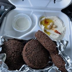 Falafel Factory - Falafel bread sampler plate with hummus and house sauce .