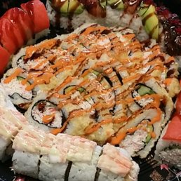 a plate of sushi and vegetables a plate of sushi and vegetables