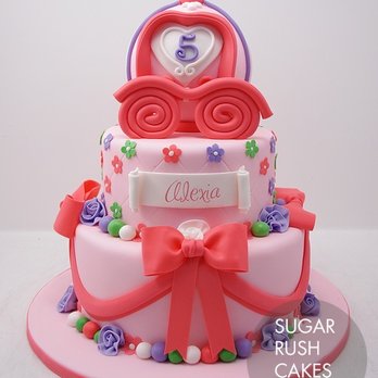 Sugar Rush Cakes - a three tiered cake decorated with pink and purple fondant - Custom Cakes Near Me