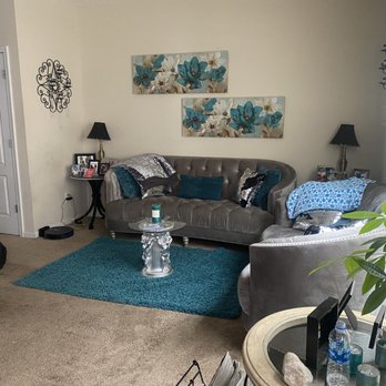 Bessie Mae Professional Cleaning - Folding blankets and placing rug on floor after vacuuming - Home Cleaning Near Me Bessie Mae Professional Cleaning - Folding blankets and placing rug on floor after vacuuming - Home Cleaning Near Me