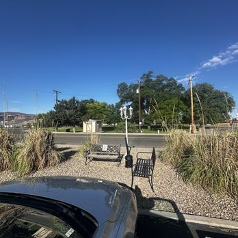 Balanced Rock Inn - Park across the street and smoking area - Hotels Near Me - Fruita, Colorado