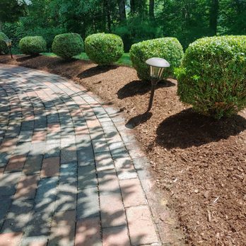 Higgins Landscaping - a brick path with a row of topiary bushes - Landscaping Near Me - Bridgewater, Massachusetts Higgins Landscaping - a brick path with a row of topiary bushes - Landscaping Near Me - Bridgewater, Massachusetts