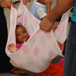 Friendswood Music and More - "Hammocking" during Kindermusik class at Friendswood Music and More.  Kindermusik classes are for infants through age 7