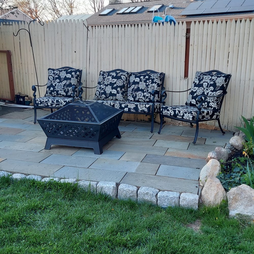 Four Seasons Landscaping - a patio with a fire pit - Landscaping Near Me Four Seasons Landscaping - a patio with a fire pit - Landscaping Near Me