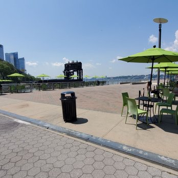 Pier i Cafe - tables and umbrellas on a sunny day - American Near Me - New York, New York Pier i Cafe - tables and umbrellas on a sunny day - American Near Me - New York, New York