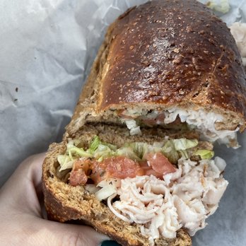 DiBella's Subs - a hand holding a sandwich - Sandwiches Near Me - Rochester, New York