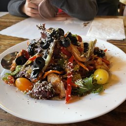 a plate of mixed vegetables on a wooden table