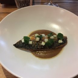 Tiny portion of fish looks rather sad in large white bowl. Tiny portion of fish looks rather sad in large white bowl.