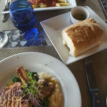 Amici Ristorante - Pork chop special with risotto and chicken parm. - Italian Near Me - Kenmore, New York