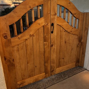Narrow Leaf - Pine double entry gate with arch top and arched latilla window. - Fences & Gates Near Me - Albuquerque, New Mexico Narrow Leaf - Pine double entry gate with arch top and arched latilla window. - Fences & Gates Near Me - Albuquerque, New Mexico