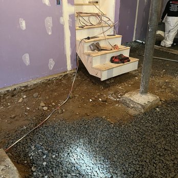 Quality 1st Basement Systems - Removal of floor under stairs and rock staging before re-pour. - Waterproofing Near Me - Cliffwood, New Jersey