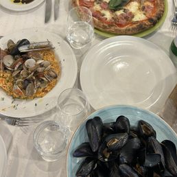 mussels , risotto , and ham and mushroom pizza