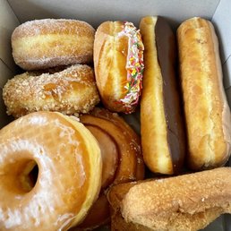Raised Donuts, Cinnamon Roll, Chocolate and Maple Bars, and Butter Milk Plain Donut Raised Donuts, Cinnamon Roll, Chocolate and Maple Bars, and Butter Milk Plain Donut