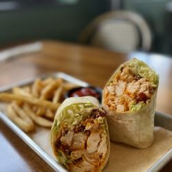 Aces Pickleball Bar & Grill - Buffalo Chicken Wrap - Grilled or deep-fried chicken tossed in Buffalo sauce, blue cheese crumbles, bacon, lettuce, soft flour tortilla