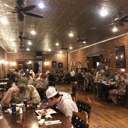 a group of soldiers eating in a restaurant a group of soldiers eating in a restaurant