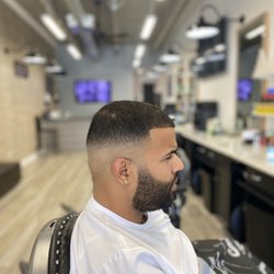 Upper Cuts Barbershop - Mid skin fade with a beard line up