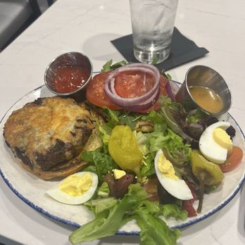 Cat Cora's Kitchen - Burger with side salad alongside - New American Near Me - Atlanta, Georgia