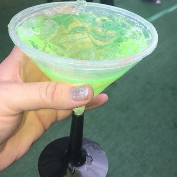 Shamrock San Diego - a hand holding a green drink - Bars Near Me Shamrock San Diego - a hand holding a green drink - Bars Near Me