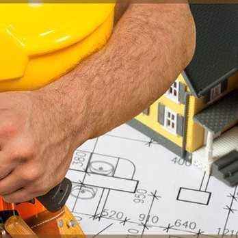 Rebel Renovations - a man holding a hammer and a model of a house - General Contractors Near Me Rebel Renovations - a man holding a hammer and a model of a house - General Contractors Near Me