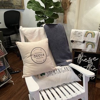Wine & Whimseys - a white rocking chair with a pillow on it - Beer, Wine & Spirits Near Me - Tucker, Georgia Wine & Whimseys - a white rocking chair with a pillow on it - Beer, Wine & Spirits Near Me - Tucker, Georgia