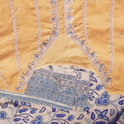 Ghansham Tailors - The design is not symmetrical. Part of the third line of silver work is missing on the left sleeve.