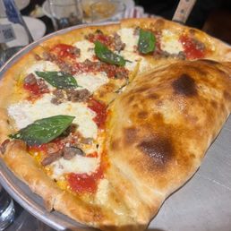 Pizza with an Alfredo pasta calzone