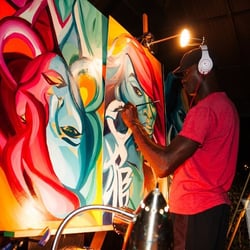 Artist on stage painting at 11AfterDark