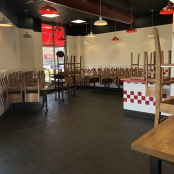 Five Guys - a dining area with tables and chairs - Burgers Near Me - Smyrna, Georgia
