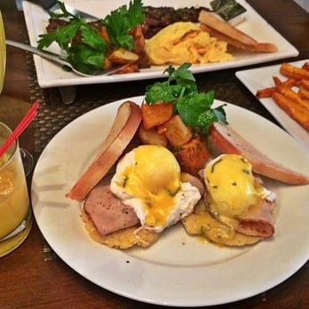 Blend - Eggs Benedict with a side of sweet potatoe fries. Steak and eggs in the back - Latin American Near Me - Long Island City, New York