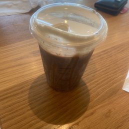 a cup of coffee on a table a cup of coffee on a table
