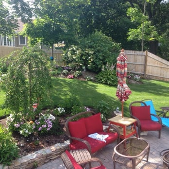 Walsh Landscaping - a patio with chairs and tables - Landscaping Near Me Walsh Landscaping - a patio with chairs and tables - Landscaping Near Me