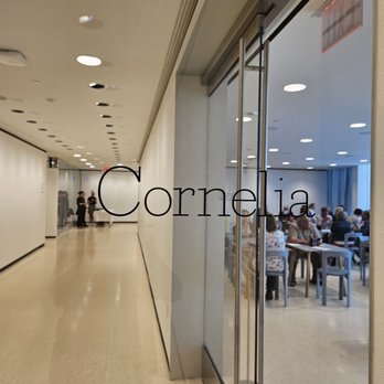 Cornelia - people sitting at tables in a conference room - Cafes Near Me - Buffalo, New York