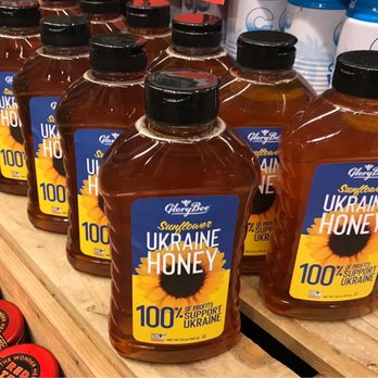 GloryBee - a row of honey bottles on a shelf - Specialty Food Near Me - Eugene, Oregon
