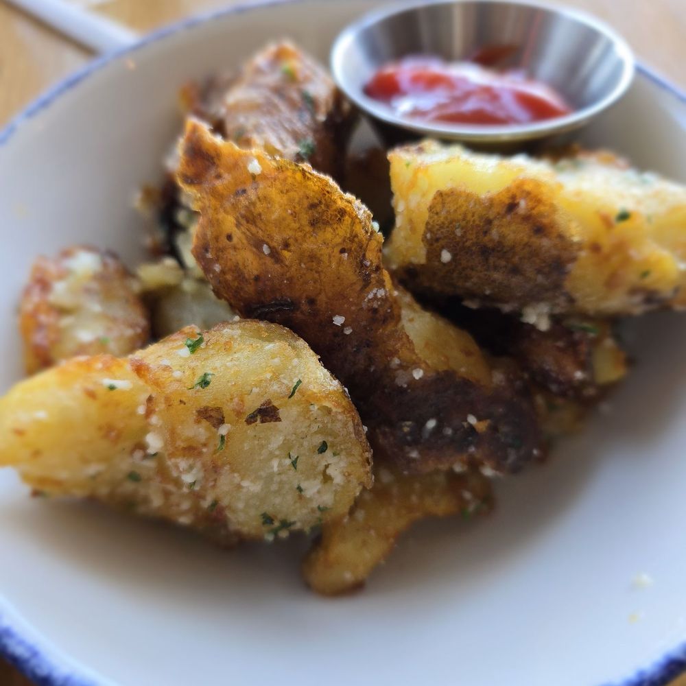 Tupelo Honey Southern Kitchen & Bar - Rosemary and Parmesan Crispy Potatoes - New American Near Me - Frisco, Texas Tupelo Honey Southern Kitchen & Bar - Rosemary and Parmesan Crispy Potatoes - New American Near Me - Frisco, Texas