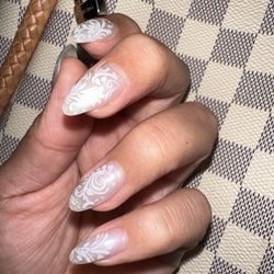 IBD Gel Nails w/ white swirl wrapped on-top of light white translucent nail color.